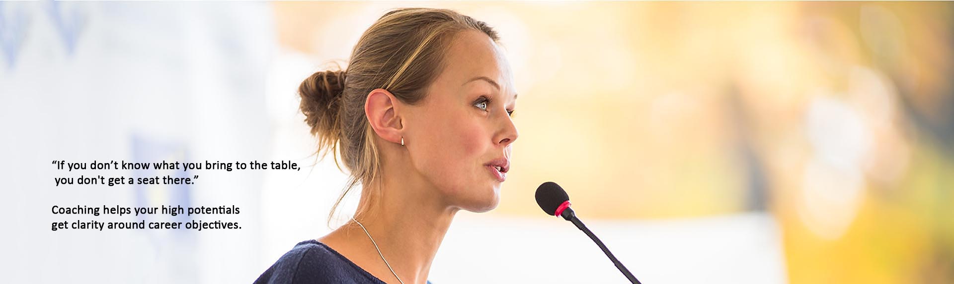 attractive business woman speaking into microphone