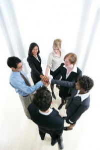 Business team right hands placed on top of each other in a circle - Ready to cheer